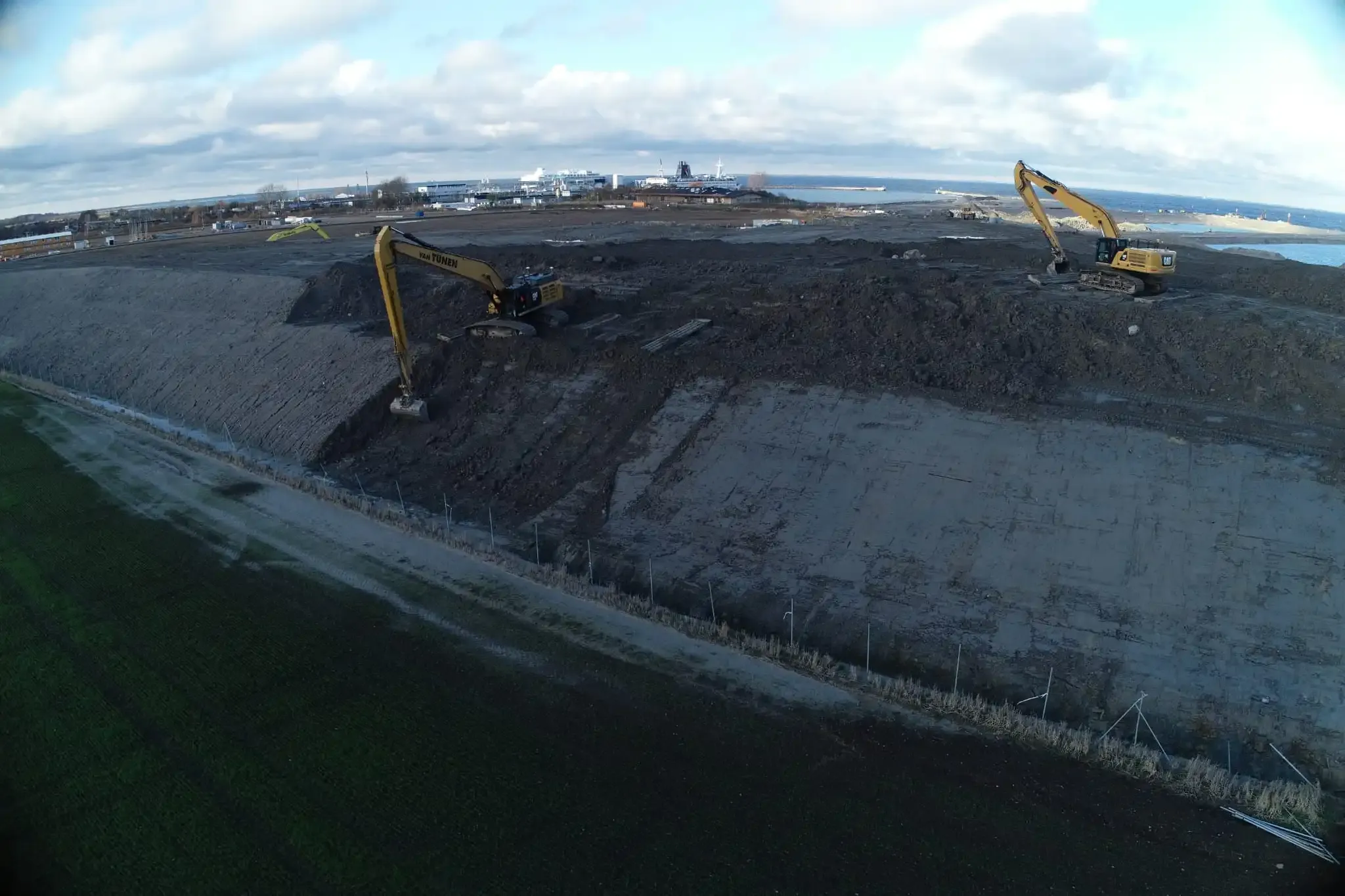 Aerial view of excavators working an embankment beside water
